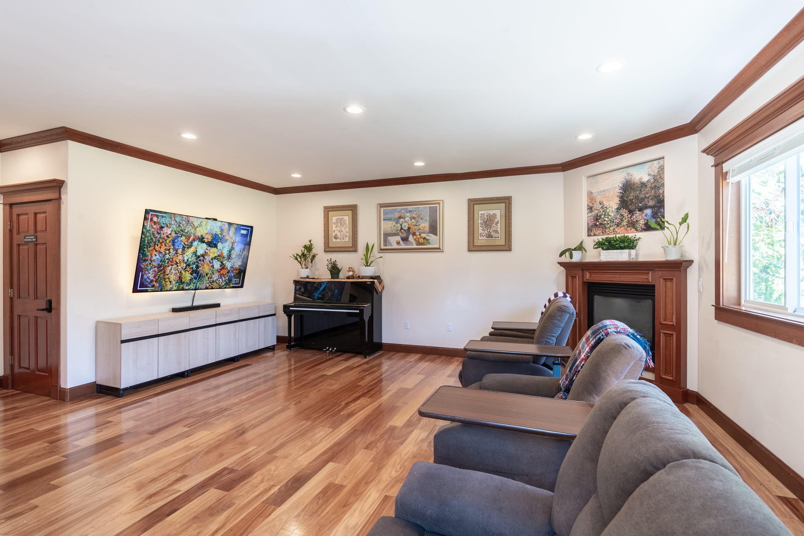 The main living room seen from the fireplace end, with recliners arranged for company.